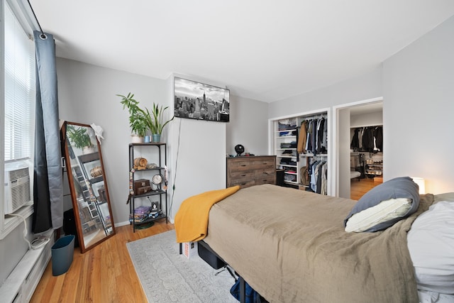 bedroom with a closet and light hardwood / wood-style flooring