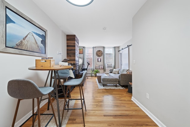 interior space with a barn door and light wood-type flooring