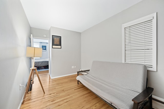 living area featuring a baseboard radiator and light hardwood / wood-style floors