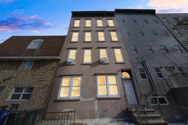 view of outdoor building at dusk