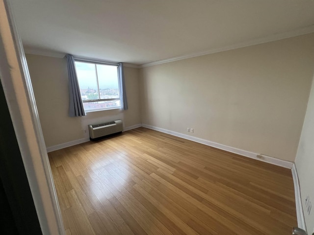 100 Manhattan Ave Unit 1104, Union City, NJ 07087 - unfurnished room featuring a wall unit AC, crown molding, and light wood-style floors
