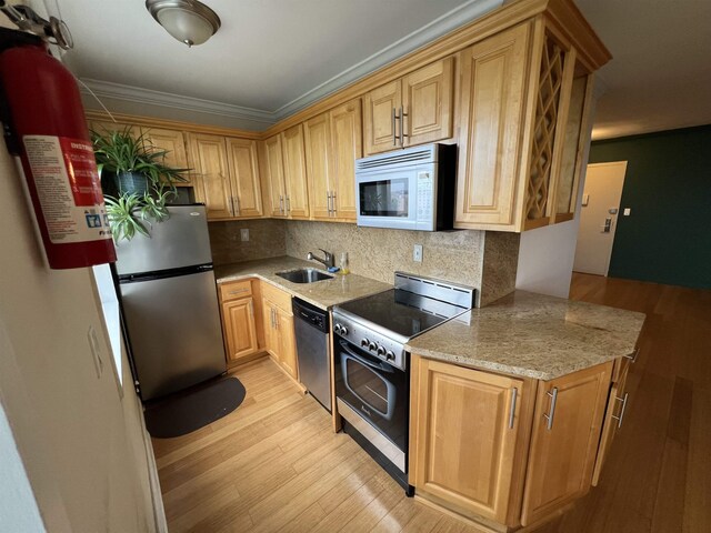100 Manhattan Ave Unit 1104, Union City, NJ 07087 - kitchen with stainless steel appliances, backsplash, light wood finished floors, light stone counters, and ornamental molding