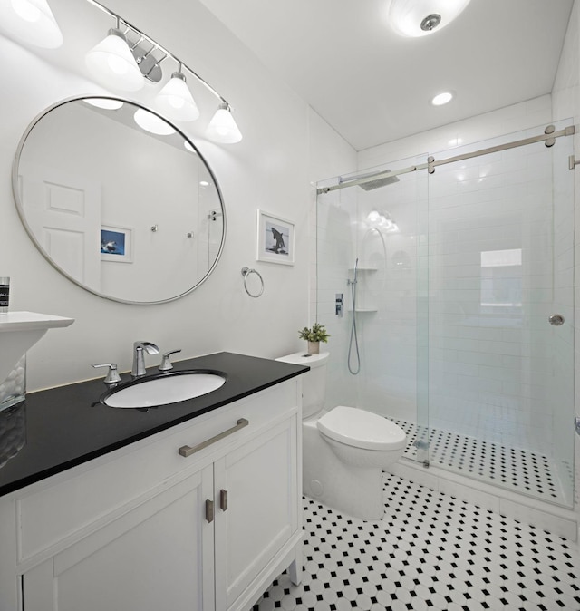 204 Jackson St Unit 9, Hoboken, NJ 07030 - bathroom with toilet, a shower stall, tile patterned floors, vanity, and recessed lighting