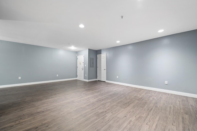 spare room featuring dark hardwood / wood-style flooring and electric panel