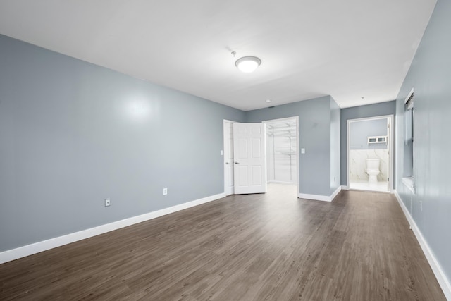 unfurnished room with dark wood-type flooring