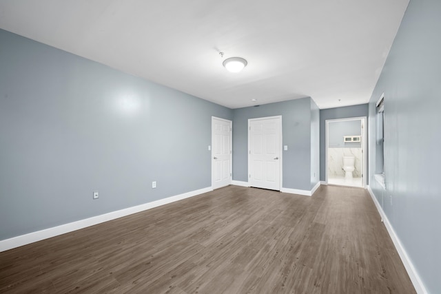 empty room with dark hardwood / wood-style floors