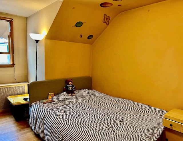 18 Messler St, East Brunswick, NJ 08816 - bedroom featuring radiator heating unit, wood finished floors, and lofted ceiling