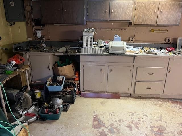 18 Messler St, East Brunswick, NJ 08816 - kitchen with electric panel, light countertops, white cabinets, and concrete floors