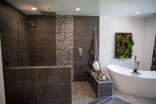 bathroom featuring a freestanding tub, tile patterned flooring, walk in shower, and recessed lighting