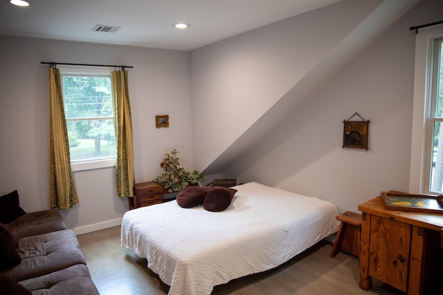 bedroom with wood finished floors, visible vents, and recessed lighting