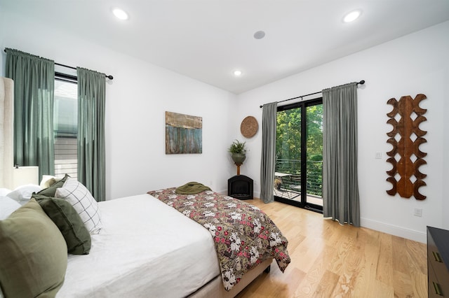 bedroom featuring access to outside and light hardwood / wood-style floors