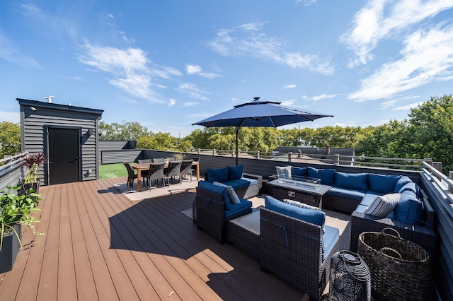 wooden deck with an outdoor living space with a fire pit