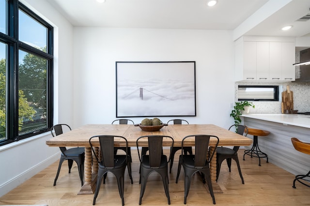 dining room with a healthy amount of sunlight and light hardwood / wood-style floors