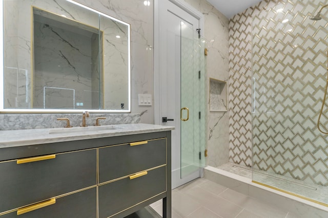 bathroom featuring vanity, tile patterned floors, and a shower with shower door