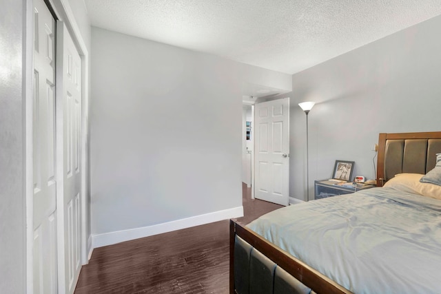 11 Cuneo Pl Unit D, Jersey City, NJ 07307 - bedroom featuring baseboards, a textured ceiling, and dark wood-style flooring