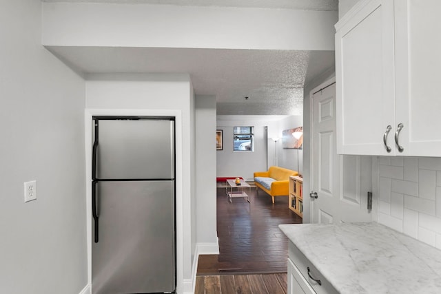 11 Cuneo Pl Unit D, Jersey City, NJ 07307 - kitchen with freestanding refrigerator, dark wood finished floors, white cabinetry, backsplash, and a textured ceiling