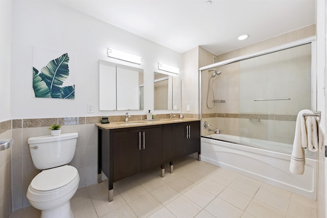 20 Newport Pkwy Unit 2008, Jersey City, NJ 07310 - bathroom with bath / shower combo with glass door, tile patterned flooring, double vanity, tile walls, and wainscoting