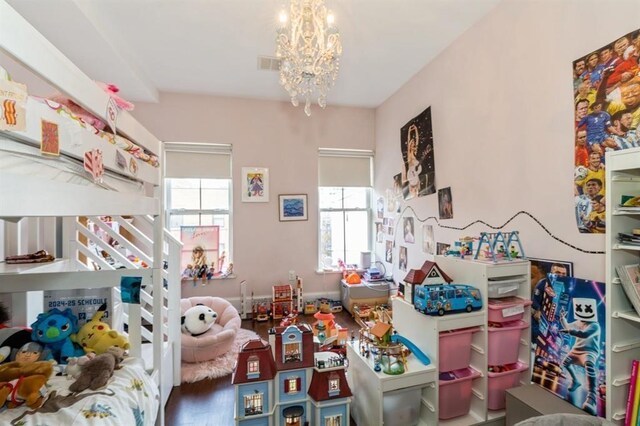 225 8th St, Jersey City, NJ 07302 - bedroom featuring a chandelier and wood finished floors