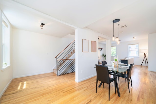 110 Morris St Unit 3R, Jersey City, NJ 07302 - dining space with stairs, light wood-style flooring, and baseboards