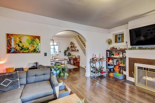 8212 2nd Ave, North Bergen, NJ 07047 - living room featuring arched walkways, a fireplace with flush hearth, wood finished floors, and stairs