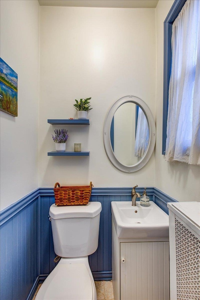 8212 2nd Ave, North Bergen, NJ 07047 - half bathroom with a wainscoted wall and vanity