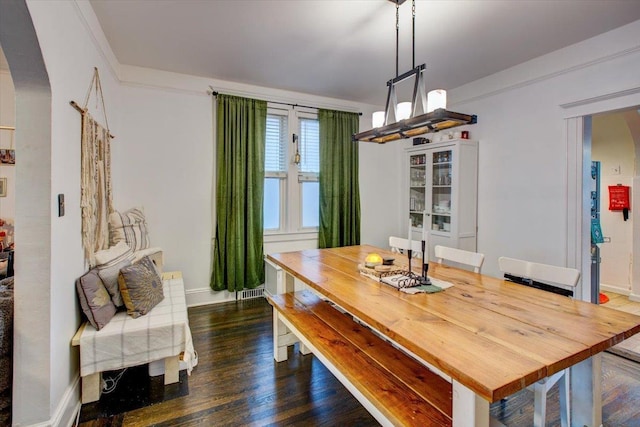 8212 2nd Ave, North Bergen, NJ 07047 - dining room featuring arched walkways, dark wood-style floors, and a chandelier