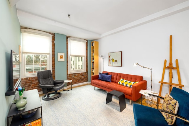 living room featuring brick wall