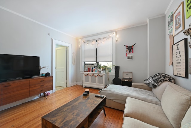 living room featuring hardwood / wood-style flooring and ornamental molding