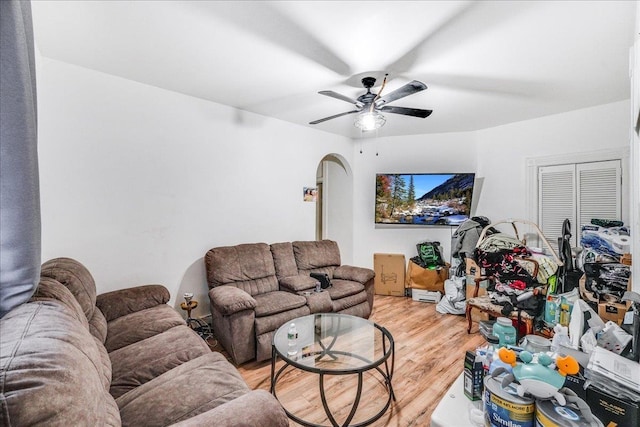 living room with ceiling fan and hardwood / wood-style flooring