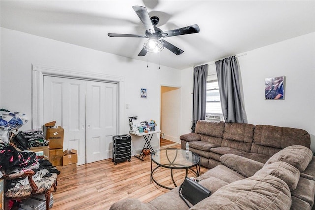 living room featuring ceiling fan and light wood-type flooring