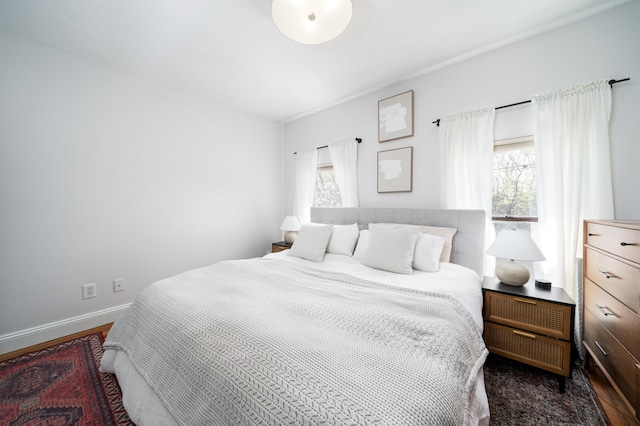 bedroom featuring baseboards and wood finished floors