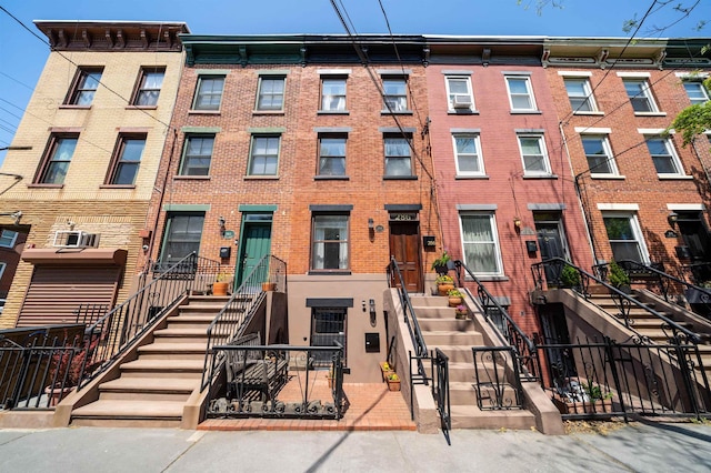 townhome / multi-family property with brick siding and fence