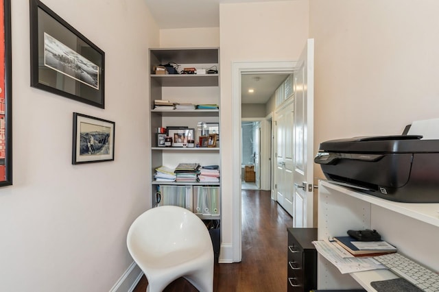interior space with baseboards and dark wood-style floors