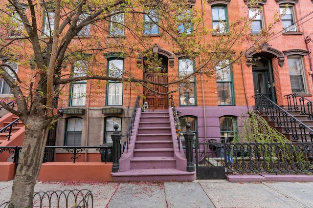 exterior space featuring fence and brick siding