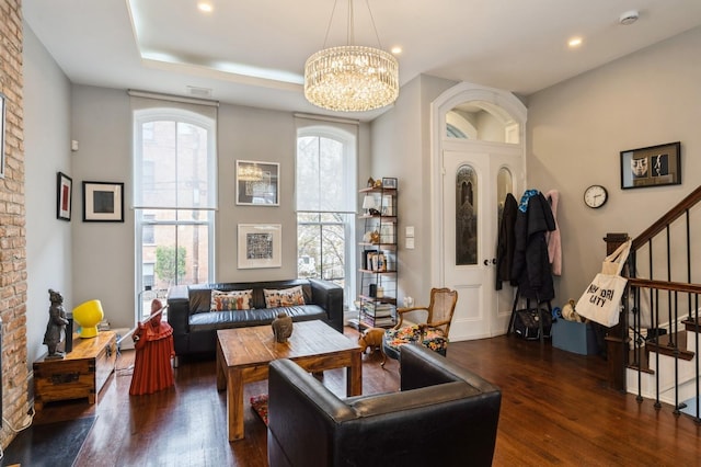 living area featuring stairway, recessed lighting, dark wood-style floors, and a chandelier