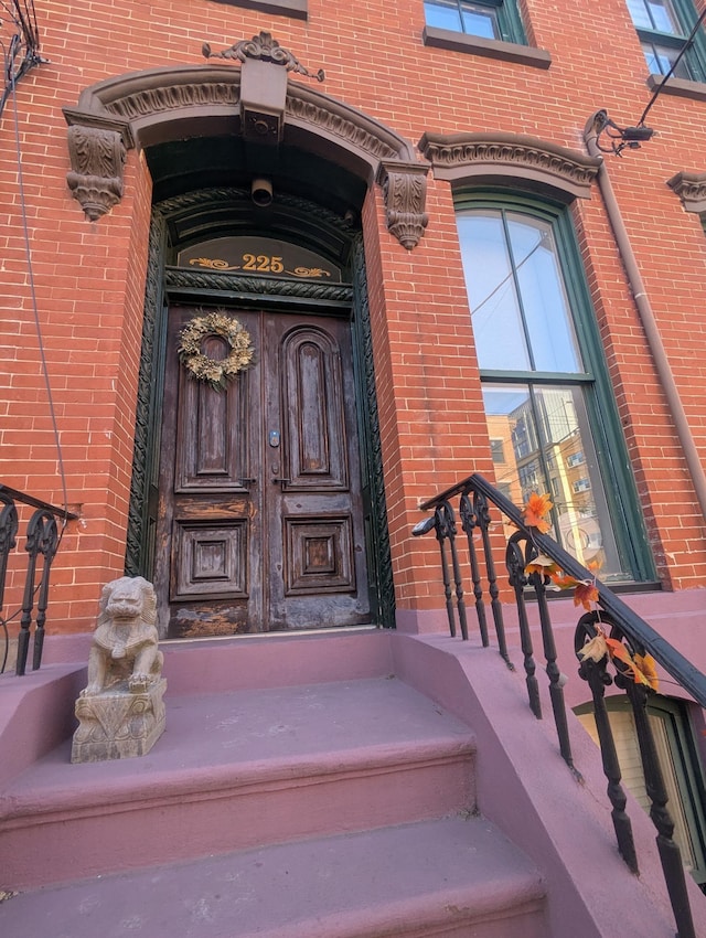doorway to property with brick siding