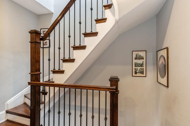stairway featuring baseboards and wood finished floors