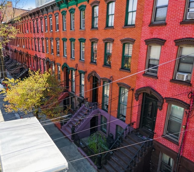 view of property featuring stairway and cooling unit