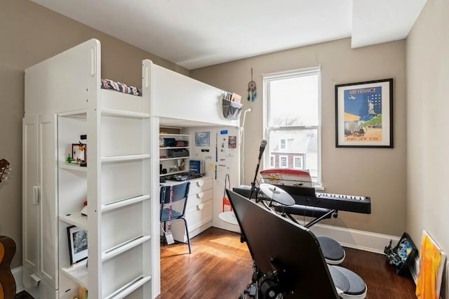 interior space with baseboards and wood finished floors