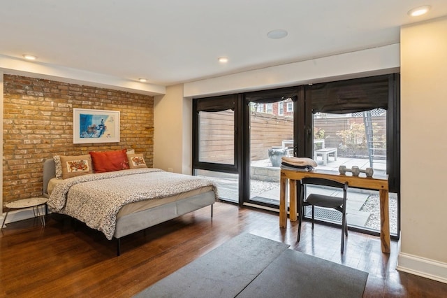 bedroom featuring dark wood-style flooring, brick wall, baseboards, access to outside, and recessed lighting