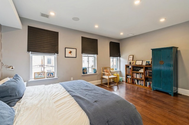 bedroom featuring dark wood-type flooring, recessed lighting, baseboards, and visible vents