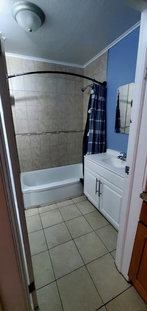 124 71st St, Guttenberg, NJ 07093 - full bathroom featuring vanity, tile patterned floors, shower / bath combination with curtain, and ornamental molding
