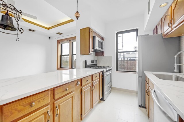 301 79th St Unit E4, North Bergen, NJ 07047 - kitchen with appliances with stainless steel finishes, a sink, healthy amount of natural light, and backsplash