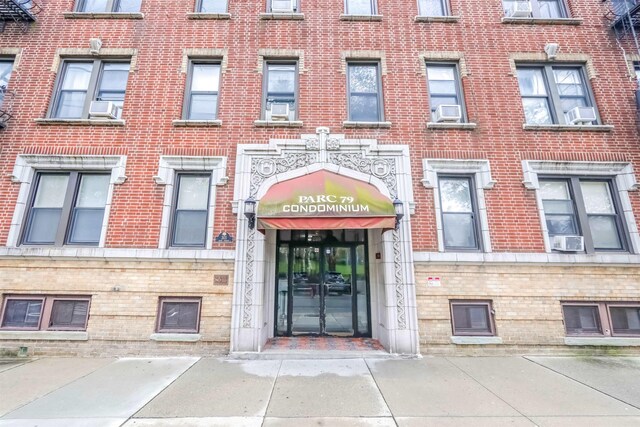 301 79th St Unit E4, North Bergen, NJ 07047 - entrance to property with brick siding and cooling unit