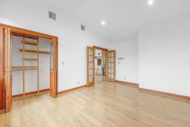 301 79th St Unit E4, North Bergen, NJ 07047 - unfurnished bedroom with french doors, light wood-style floors, baseboards, recessed lighting, and high vaulted ceiling