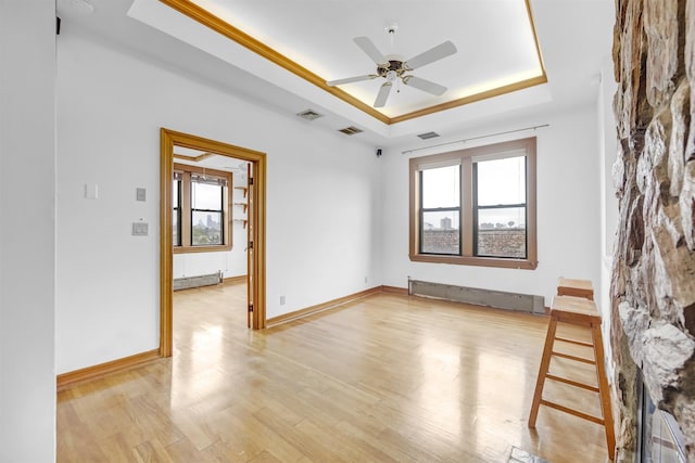 301 79th St Unit E4, North Bergen, NJ 07047 - unfurnished room with a tray ceiling, a ceiling fan, light wood finished floors, a baseboard radiator, and radiator heating unit