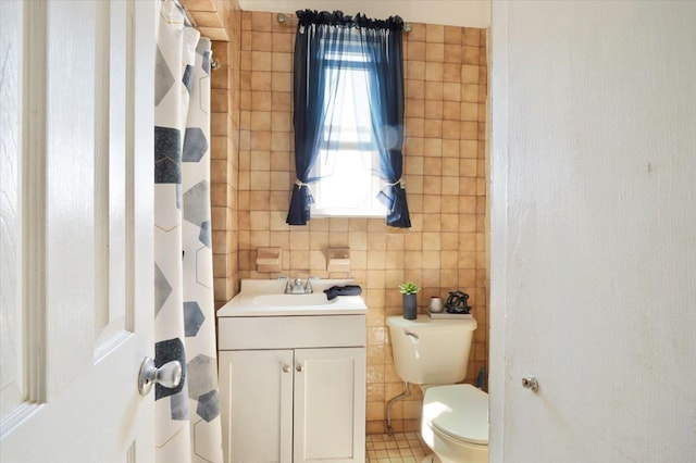 4007 Grand Ave, North Bergen, NJ 07047 - bathroom with tile walls, toilet, and vanity