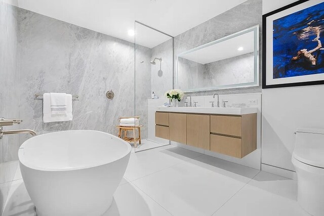 320 Adolphus Ave Unit 909, Cliffside Park, NJ 07010 - bathroom featuring double vanity, tile walls, a soaking tub, and a walk in shower