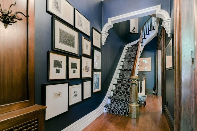 staircase with baseboards and hardwood / wood-style flooring