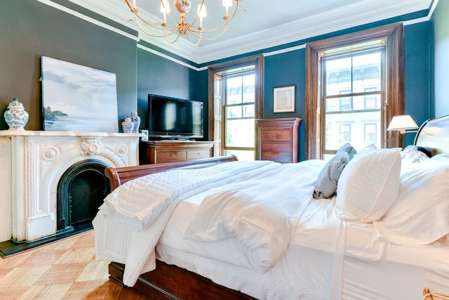 bedroom featuring crown molding, a fireplace with raised hearth, and a chandelier